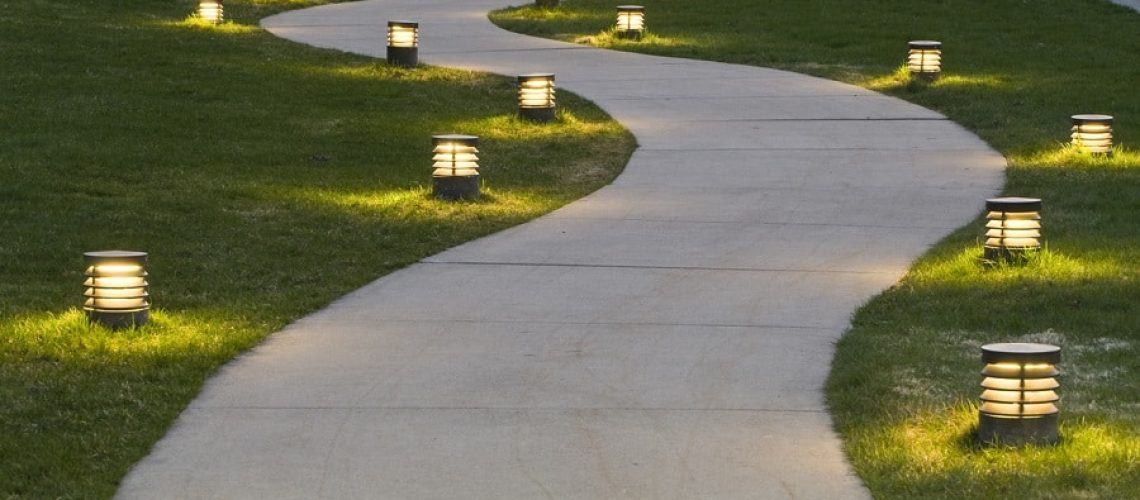 A path through the grass lit by lanterns